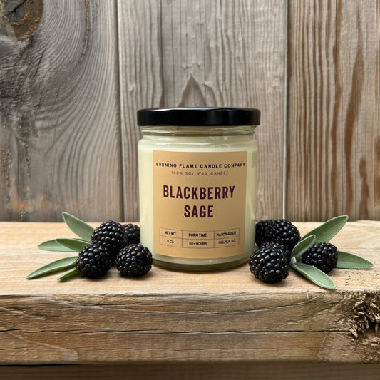 A jar candle labeled 'Blackberry Sage' by Burning Flame Candle Company.