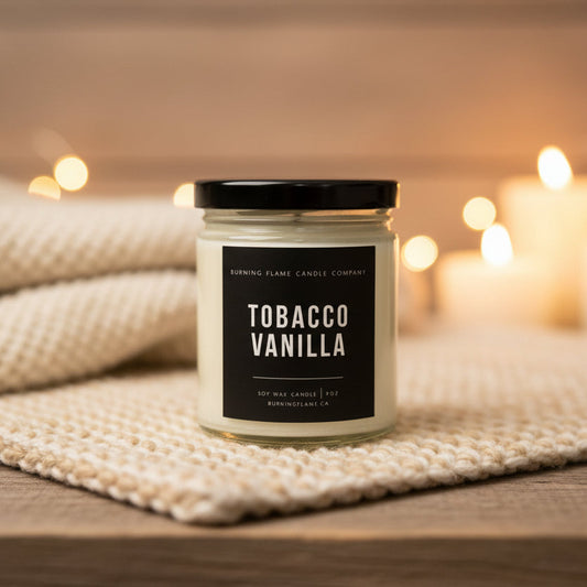 A jar candle labeled Tobacco Vanilla by Burning Flame Candle Company.